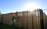 Highlighting quality fencing Manchester installations with distinct wooden and metal designs in a serene garden.