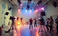 영상업체 showcasing a vibrant film studio with dynamic crew members and production equipment.