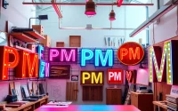 Showcase of creatively designed pm signs in a modern studio, highlighting craft and professionalism.